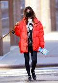 Emily Ratajkowski porte une doudoune rouge et des leggings noirs alors qu'elle sort promener son chien à New York