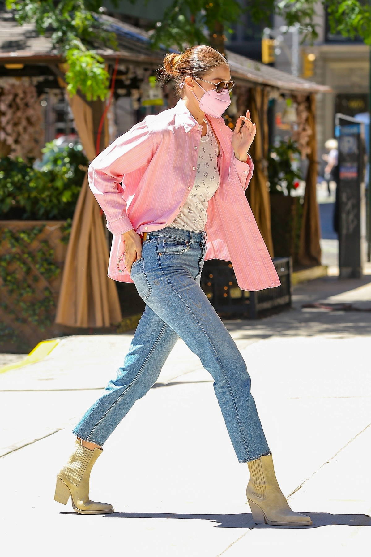 Gigi Hadid looks fab in an unbuttoned pink shirt and blue jeans as she arrives back at her apartment in New York City